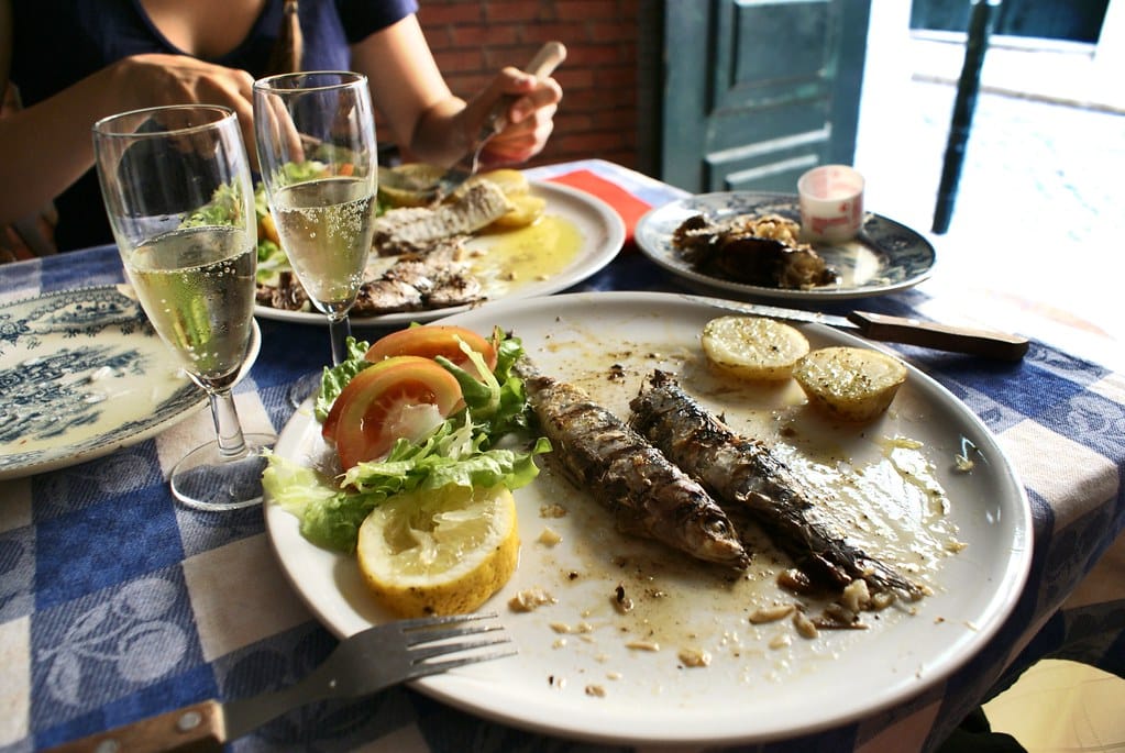 Sardines grillées, pomme de terre et salade avec un verre de vin vert légèrement pétillant = Le bonheur simple à Lisbonne.